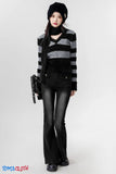 Person wearing a striped sweater and black pants with a white background