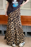 Person wearing a leopard print skirt with a casual outfit indoors.