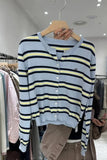Striped sweater on a hanger in a clothing store