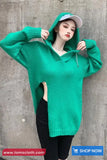 Person wearing a green oversized sweater against a gray concrete wall with 'www.tomscloth.com' and 'SHOP NOW' text.
