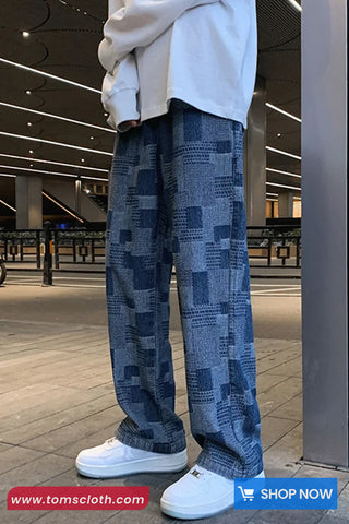 Person wearing blue patterned pants and white sneakers in an indoor setting with 'Toms Cloth' branding.