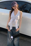 Woman wearing a striped top and cap, standing next to a white vehicle.