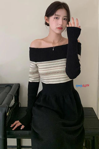 Woman wearing a black and white dress with long sleeves, sitting on a piano.