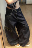 Person wearing dark blue wide-leg jeans with leopard print accents indoors.