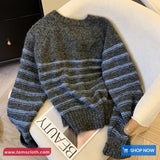 Gray and blue striped sweater on a mannequin with 'Toms Cloth' branding.