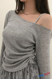 Gray off-shoulder sweater worn by a mannequin against a neutral background