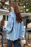 Woman wearing a denim jacket with a blurred background
