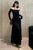 Woman wearing a black off-shoulder dress and cap against a plain wall.