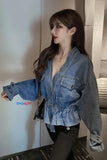Woman wearing a blue denim jacket with a brand logo in an indoor setting