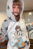 Person wearing a gray hoodie with star patterns and a colorful design on the front.