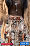 Person wearing a patterned skirt with a 'Shop Now' button visible