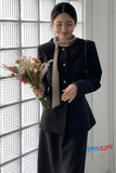 Woman holding flowers indoors with a textured wall background