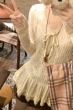 Person wearing a lace top and plaid skirt in a casual setting