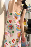 Person wearing a colorful dress with floral and abstract patterns in a casual setting.