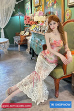 Woman in a floral dress sitting on a chair in an elegant room with decorative elements.