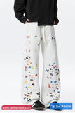 White sweatpants with colorful patterns worn by a person on a white background