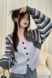 Woman wearing a gray and white striped sweater over a light blue cardigan.