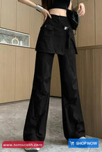 Person wearing black pants in a kitchen setting with 'www.tomscloth.com' branding.