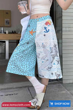 Person wearing a colorful skirt with nautical patterns in an indoor setting.